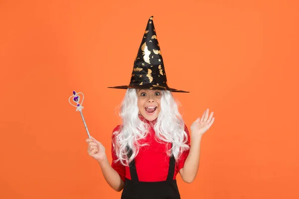 Happy girl wear witch hat holding magic wand to create enchantment on halloween, happy halloween wonder — Stock Photo, Image
