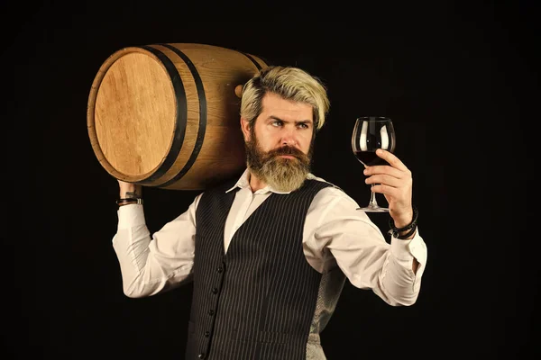 Homemade wine. Producing wine family tradition. Man bearded hipster wooden barrel for wine black background. Advice on Buying Old and Rare wines. Fermentation product. Natural wine. Winery concept