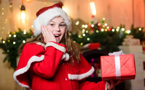 La Navidad es tiempo de dar. Santa Claus niña. Presente de compras. Niña elfa. Regalo navideño. Niña con sombrero rojo. Regalo de vacaciones. En Navidad. Caja de regalo. Feliz año nuevo. Regalo para ti —  Fotos de Stock