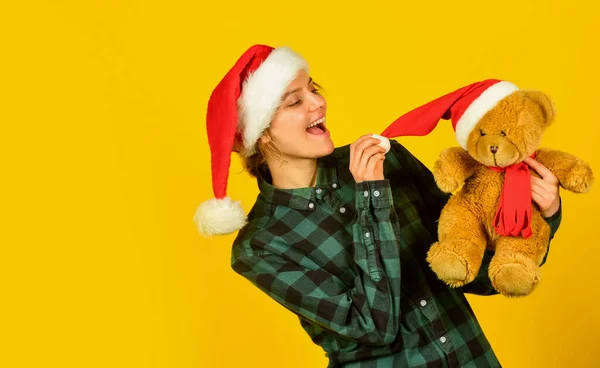 Playful lady smiling face. Play with toy. Santa Claus. Pretty woman celebrate christmas. Christmas memories from childhood. Girl with teddy bear. Charity and kindness. Lovely hug. Christmas spirit