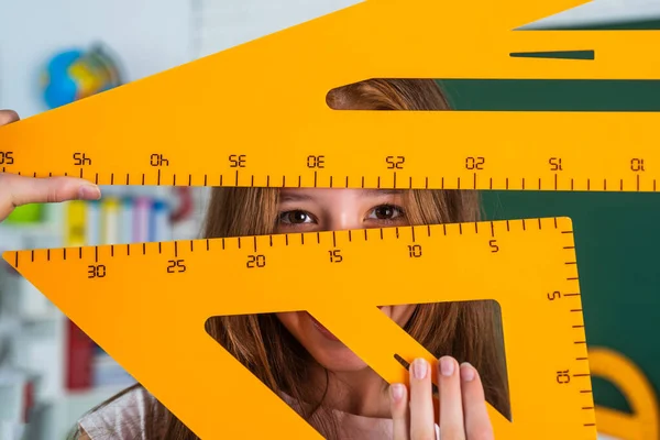 Trabalho menina alegre na sala de aula da escola com régua ferramenta triângulo de matemática, educação moderna — Fotografia de Stock