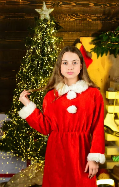 Santa helper elf at christmas tree. christmas tree with lights. nice and cosy room. small girl wait new year. xmas party is on. happy childhood. this winter night be bright — Stock Photo, Image