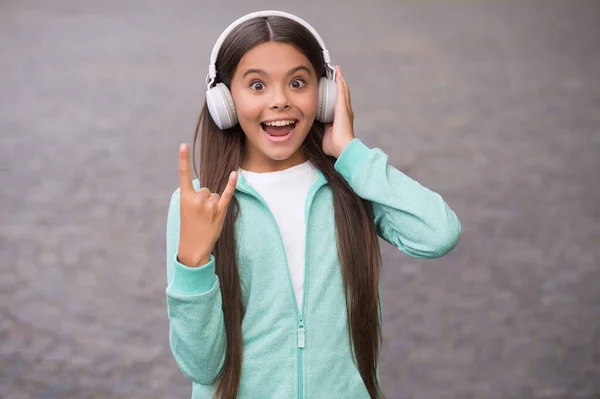 Funny school child listen music or audio book in headphones for education and joy, modern life and fun — Stock Photo, Image