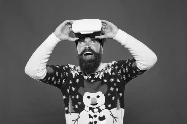Virtual community. Future technologies. Virtual life. Man celebrate christmas virtual reality device. Online communication. Video call. Bearded hipster play game vr. Happy new year. Cyber gaming