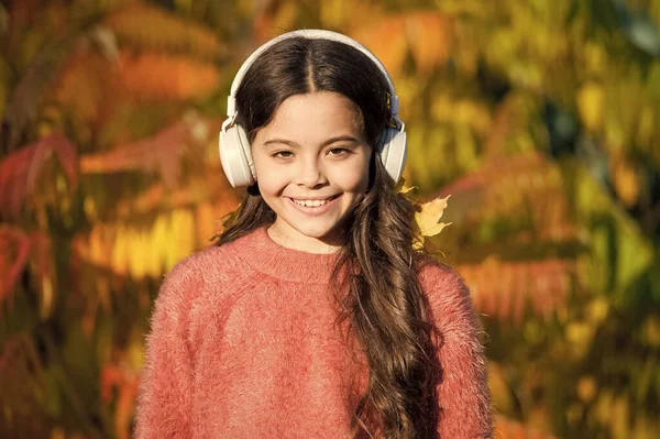 Goditi la giornata autunnale. L'autunno cammina con belle canzoni. Audiolibri educativi e scaricabili per bambini. Ragazza rilassante vicino albero autunnale con le cuffie. Musica per l'umore autunnale. Canzone d'ascolto — Foto Stock