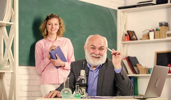 Uma ferramenta útil. educação química. aluno e tutor com laptop. de volta à escola. estudante menina a bordo. professor maduro com copo e microscópio. lição de biologia. Investigação científica e biotecnológica — Fotografia de Stock