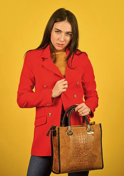 Stylish accessories. Beauty brunette. Fashionable woman in jacket. Fashion autumn winter. female trendy beauty. handbag and accessories. Trendy girl holding small leather bag in hand — Stock Photo, Image