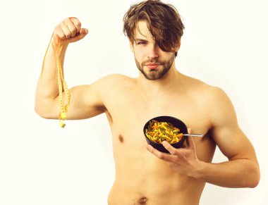 Kafkas maçosu elinde makarna ve mezura ile siyah kase tutuyor.