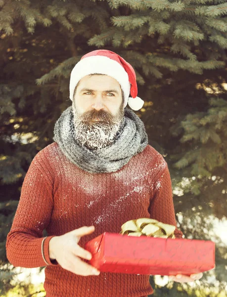 Handsome santa man with gift — Stock Photo, Image