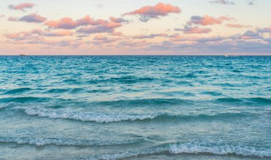 Romantic summer vacation on sunset seascape. Sea sunset on ocean. Sunset seascape at summer vacation. Sunrise with sea beach. Dramatic sunrise horizon at sea. Sea waves.