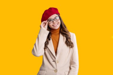 School time. Teen girl isolated on yellow. Girl wearing autumn coat. Autumnal fashion and teen style. Fall season style. Back to school. Teen girl in autumn fashion style.