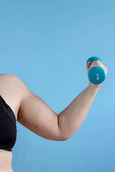 Woman holding dumbbell in hand