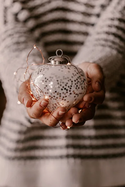 Vintage Christmas tree ornament in woman hands. Christmas mood a