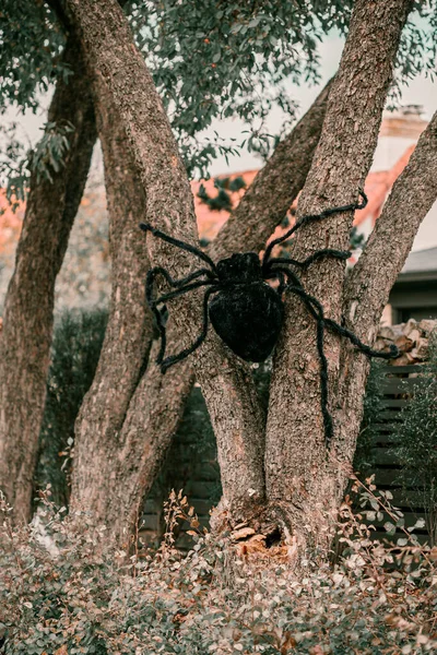 Scary spooky Halloween house decorations. Halloween season. October 31 spooky day. Trick or treat kids holiday. Scary witch, ghost, spiders, clown, pumpkins, skeleton decor. Coffin on the grass near t