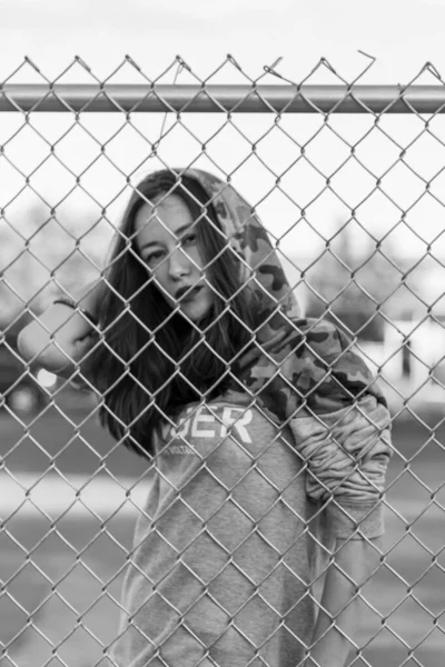 Girl against the rules. Rebel girl near the wired fence. Protesting on street. Stop the border. Hoping for the good future. Girl against the rules. Lack of freedom. Fight for the human right. Hoping.