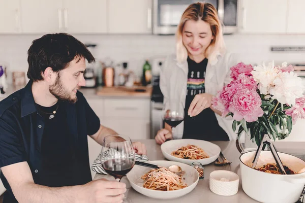 Family dinner. Pasta meal. Delicious food and wine. Discussing the say during lunch. Laughing, talking. Gathering with food. Home cooking. Stay home and cook. Eat, drink, laugh.