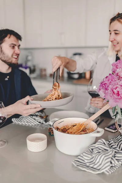 Family dinner. Pasta meal. Delicious food and wine. Discussing the say during lunch. Laughing, talking. Gathering with food. Home cooking. Stay home and cook. Eat, drink, laugh.