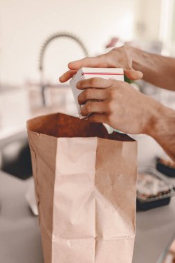 Restorandan paket paket yiyecek dağıtımını açıyorum. Çin yemeği siparişi. Aile yemeği. Yemek yapmak yok. Yeni normal. Geri dönüşüm aracı paketi. Sero atıkları. Karantina hayatı. Adam yemeğini çıkardı. Öğle yemeği vakti.