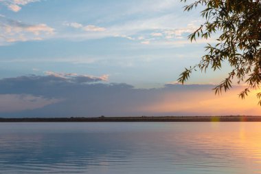 Nehrin üzerinde renkli günbatımı, gökyüzü yansıması