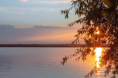 Nehrin üzerinde renkli günbatımı, gökyüzü yansıması