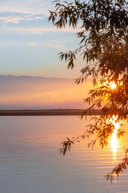 Nehrin üzerinde renkli günbatımı, gökyüzü yansıması