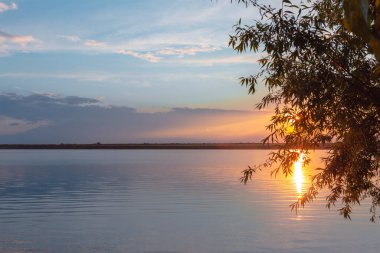 Nehrin üzerinde renkli günbatımı, gökyüzü yansıması