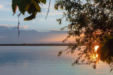 Nehrin üzerinde renkli günbatımı, gökyüzü yansıması