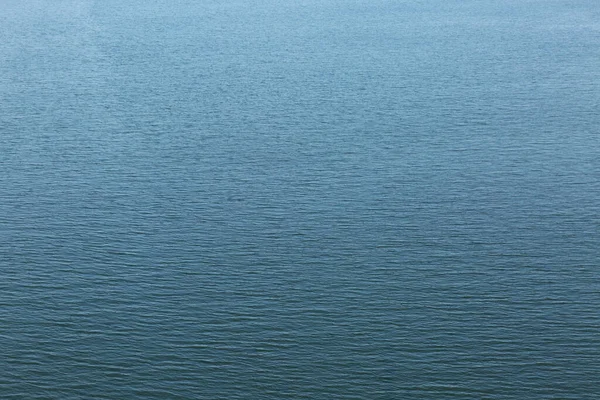 A sign above a body of water. High quality photo