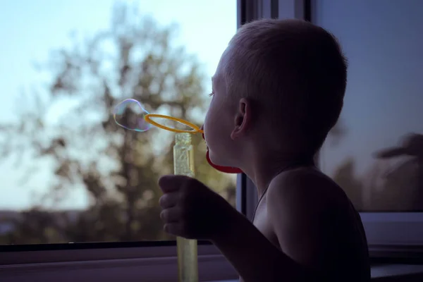 Junge Offenen Fenster Pustet Seifenblasen — Stockfoto