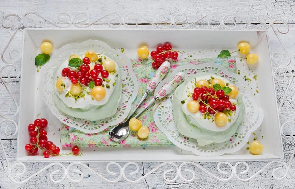 Cake Pavlova with Matcha tea and fresh berries, selective focus