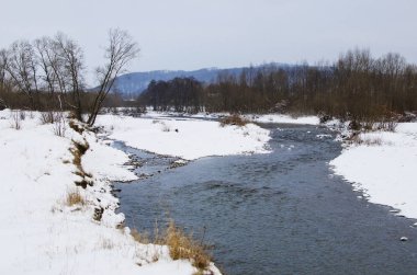 Donmuş kış manzarasında nehir akışının panoramik görünümü 