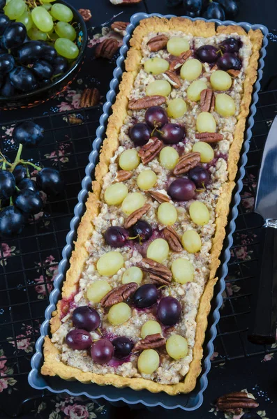 close-up of walnut caramel tart in cake tin