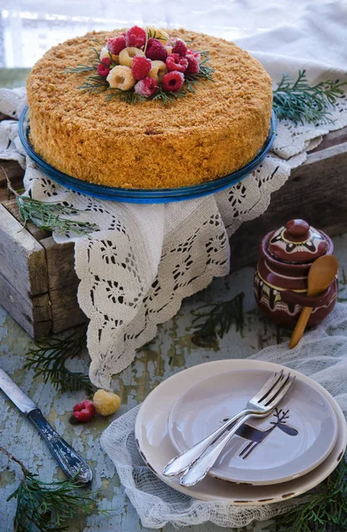 close up view of homemade cake on cake stand on rustic backdrop