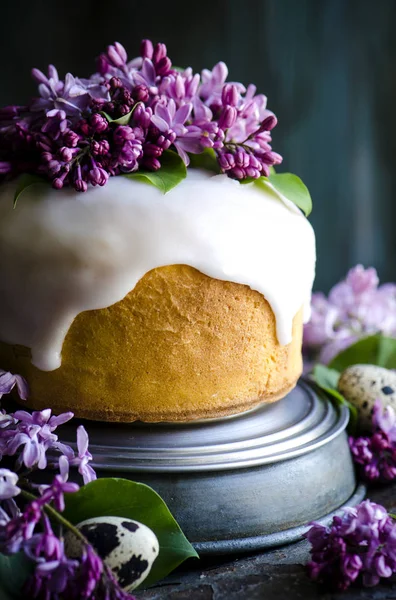 Easter carrot cake decorated with purple lilacs, selective focus