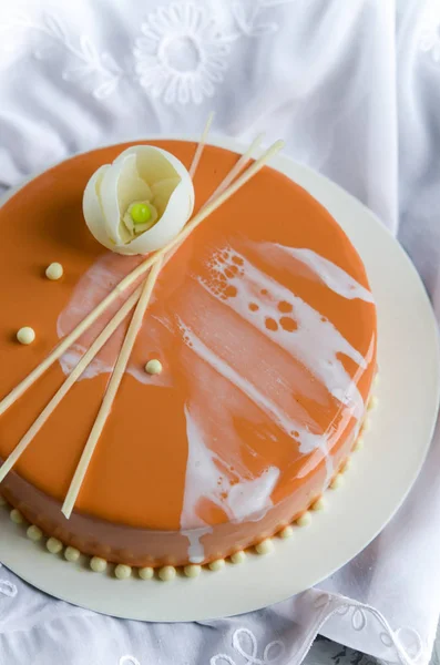 Apricot mousse cake under mirror glaze with pistachio cream
