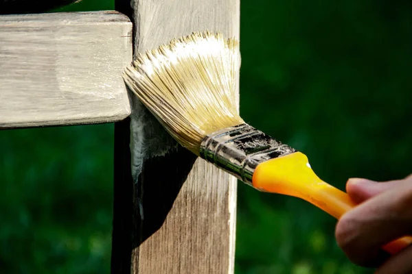 painting wooden boards with white paint