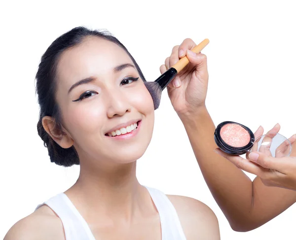 Young beautiful woman using a make-up brush, bright natural back — Stock Photo, Image