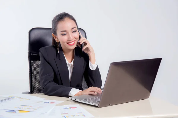 Young businesswoman working in office, typing, using computer an