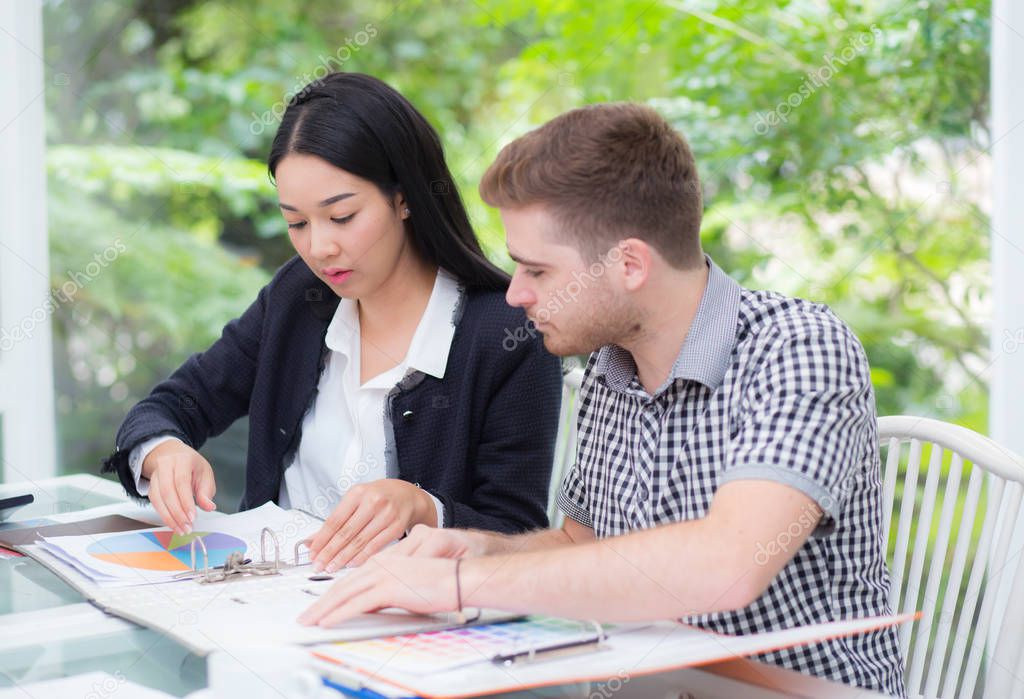 young business people making meeting and looking at document for