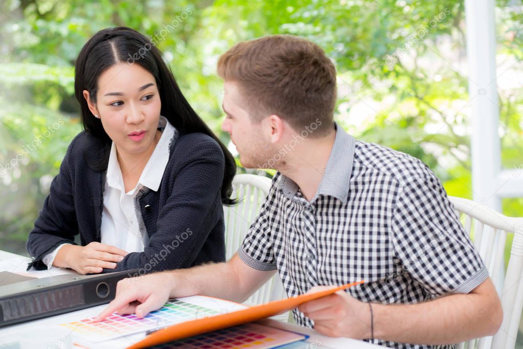 young business people making meeting and looking at document for