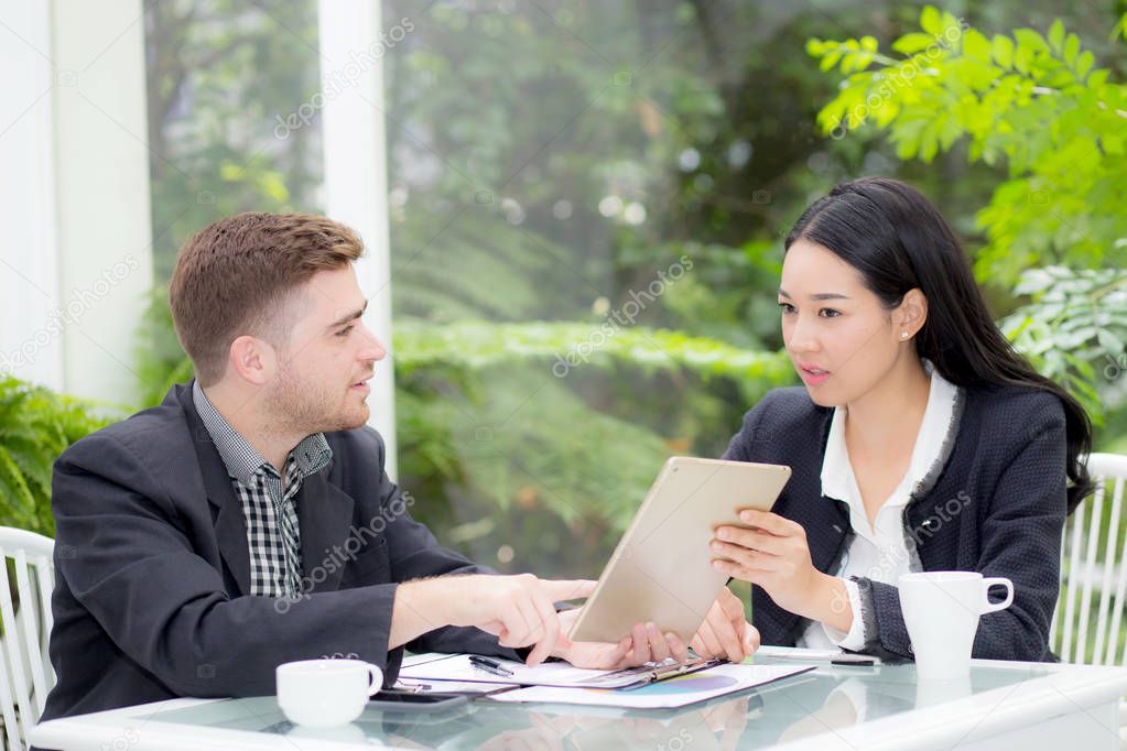 business man and woman people making meeting and looking at tabl