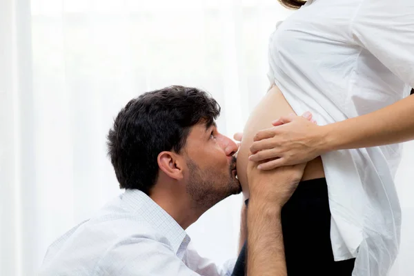 Close up husband kiss pregnant woman belly - love of father to t — Stock Photo, Image