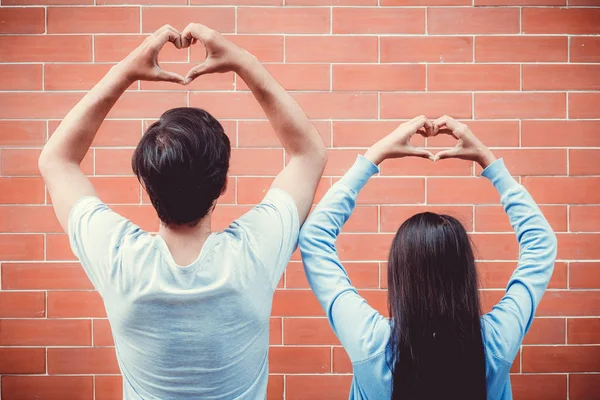 Joven asiático pareja feliz en amor con gesto mano corazón forma o —  Fotos de Stock