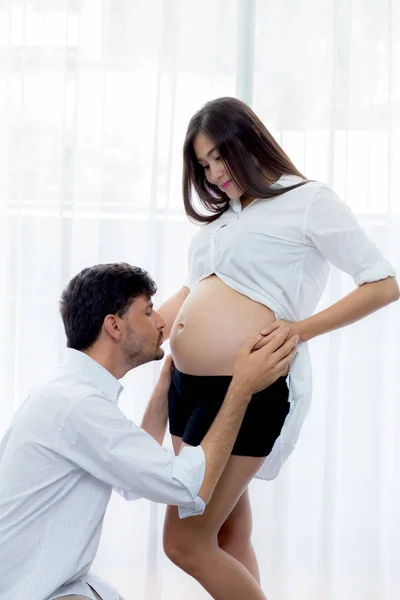 Close up husband kiss pregnant woman belly - love of father to t — Stock Photo, Image