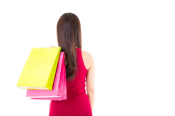 Vista trasera de la mujer con bolsas de compras. hermosa chica en rojo dr — Foto de Stock