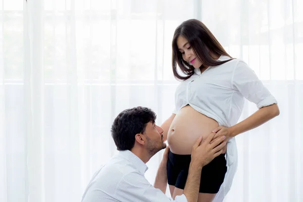 Close up husband kiss pregnant woman belly - love of father to t — Stock Photo, Image