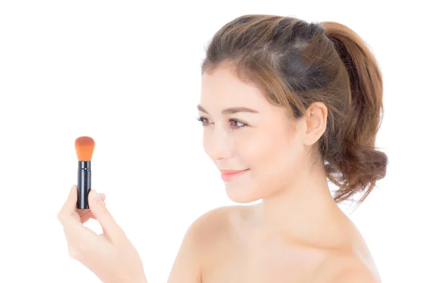 Beauty asian woman applying make up with brush of cheek isolated — Stock Photo, Image