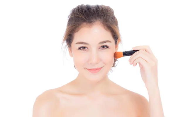 Beauty asian woman applying make up with brush of cheek isolated — Stock Photo, Image