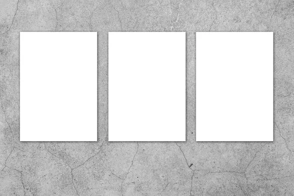Blank white paper board at grunge cement wall texture background