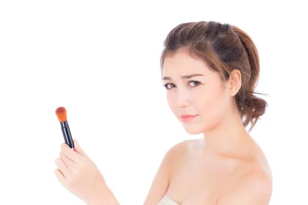 Beauty asian woman applying make up with brush of cheek isolated — Stock Photo, Image